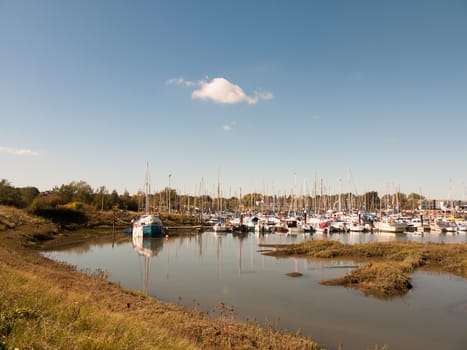 landscape view scene of boats moored in dock marina harbour; essex; england; UK