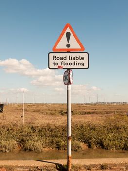 dock road sign red triangle exclamation road liable to flooding; essex; england; UK