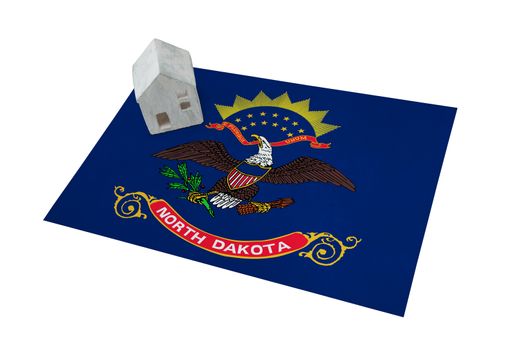 Small house on a flag - Living or migrating to North Dakota