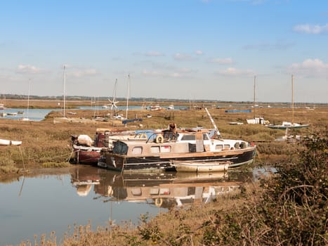 boats parked along estuary marshland in tollesbury maldon; essex; england; UK