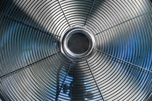 Vintage spinning ventilator with a cold blue background