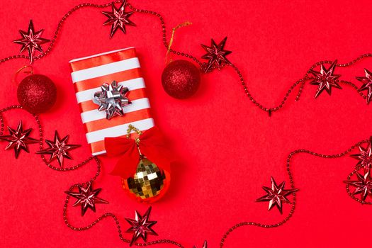 Christmas red background with gift and decoration on the red background