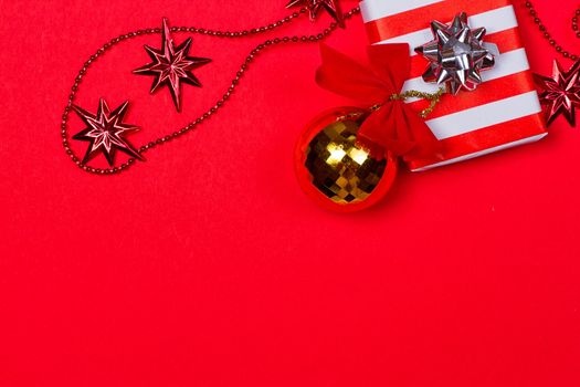 Christmas red background with gift and decoration on the red background