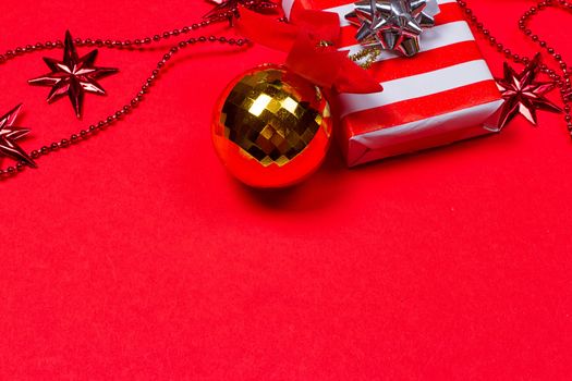 Christmas red background with gift and decoration on the red background