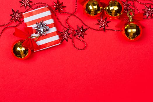 Christmas red background with gift and decoration on the red background