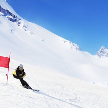 Giant Slalom ski racer skiing downhill in high mountains, Solden, Austria