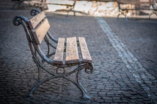 closeup of bench in a alley in sunny day