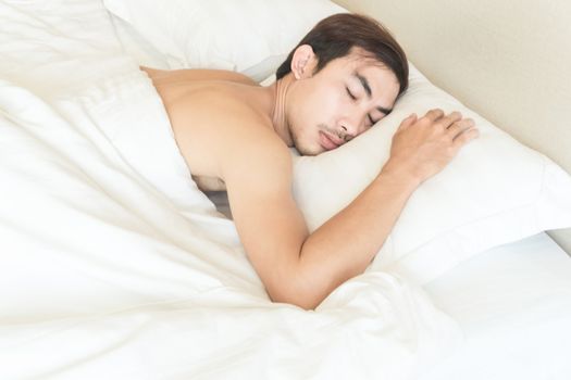 Closeup man sleeping on bed, health care and medical concept, selective focus