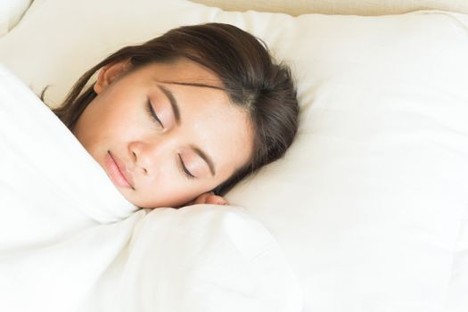 Closeup young woman sleeping with happy face in the bed, copy space