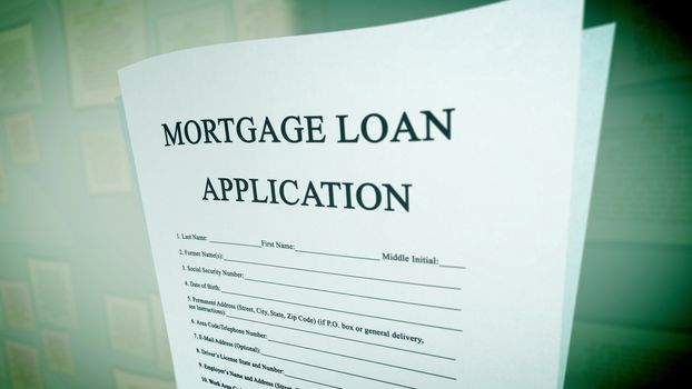 Astonishing 3d rendering of a mortgage loan application presented aslant in two pages in the green background on a computer screen. The heading is in capital letters. The extra info is lower case.