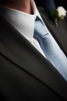 Close up of a blue tie knot on a groom or groomsmen.