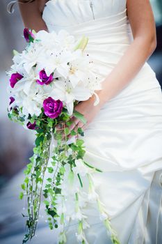 This shot focuses on the gorgeous bouquet being held by the bride.