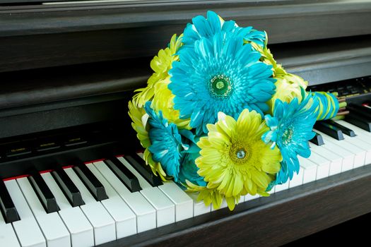 Nice green and blue boquet on piano.