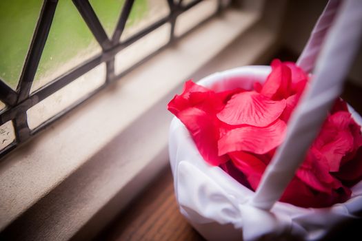 Rose Petals in Basket sitting on a window ledge.