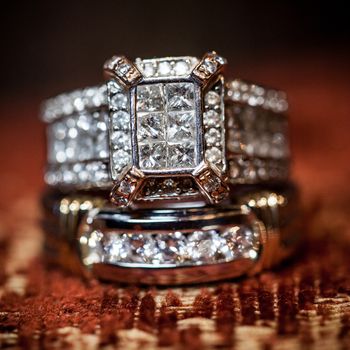 Close of gorgeous diamond wedding ring on a textured background.
