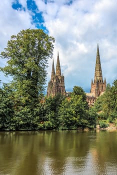 A view of the three spires at Lichfield cathedral from across minster loop upright vertical format
