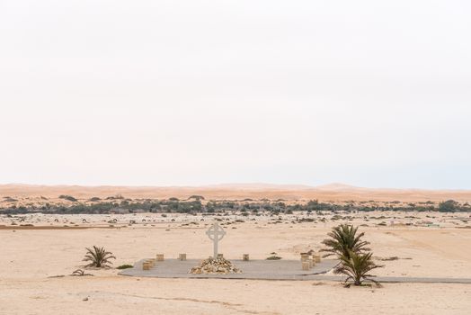 Part of the cemetry in Swakopmund in the Namib Desert on the Atlantic Coast of Namibia. The Swakop River and sand dunes are in the back