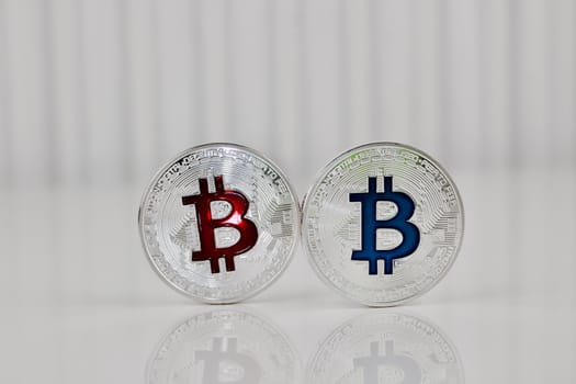 Digital currency physical silver bitcoin coin red and blue scene.