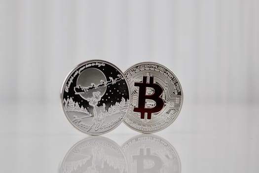 Digital currency physical silver bitcoin coin and christmas money.