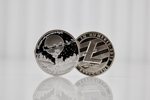 Digital currency physical silver christmas litecoin coin on the white background.
