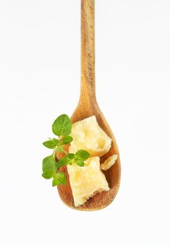 parmesan cheese and oregano on wooden spoon