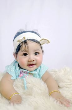 Asian Smiling baby girl crawling in bedroom