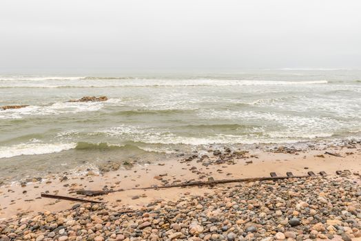 Rusted railroad tracks at the mouth of the Swakop River at Swakopmund in the Namib Desert
