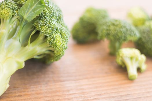 Fresh broccoli over rustic wooden background - healthy or vegetarian food concept Top view.
