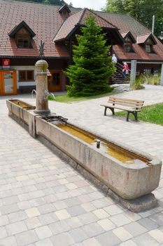 Blue stone water fountain with double tubs and two taps