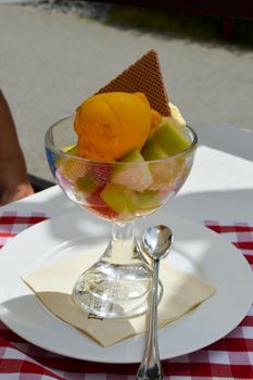 Fresh fruit salad with a bowl of melon ice cream