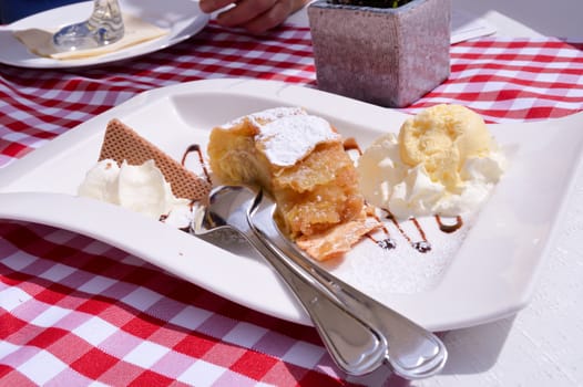 Strudel with a ball of vanilla ice cream and whipped cream