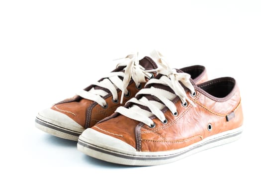 Old dirty sneaker on white background.Male Brown Leather Shoe.