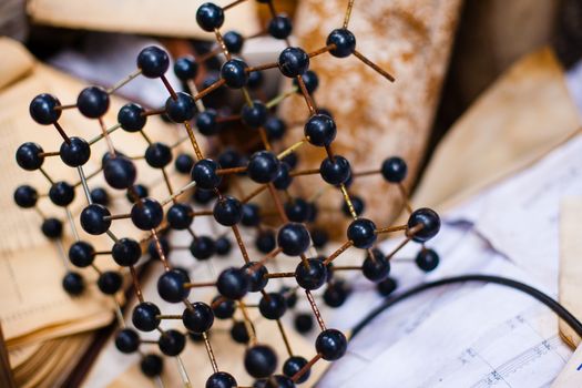 Old rusty square plastic model of molecule grid among of unnecessary trash of things