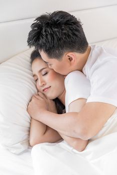 Young loving couple in the bed. Modern lifestyle concept