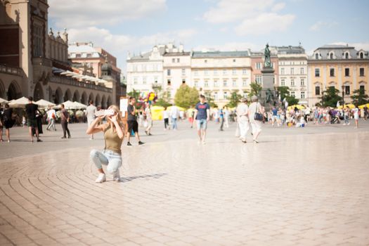 Krakow, Poland Tourist taking photos with his smart phone in historical center of city