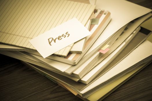 Press; The Pile of Business Documents on the Desk