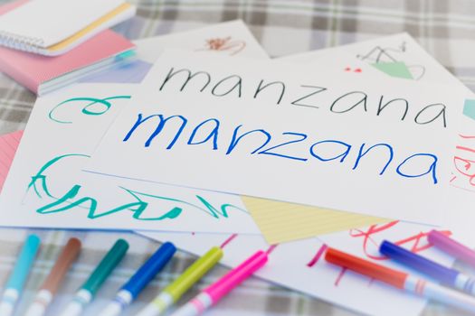 Spanish; Kids Writing Name of the Fruits for Practice (Translation; Apple)