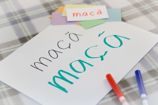 Portuguese; Kids Writing Name of the Fruits for Practice (Translation; Apple)