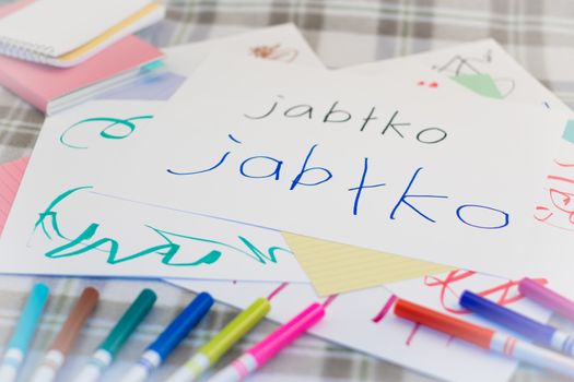 Polish; Kids Writing Name of the Fruits for Practice (Translation; Apple)