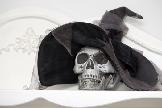 Human skull in a white cabinet. Halloween theme