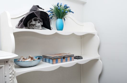 Human skull in a white cabinet. Halloween theme