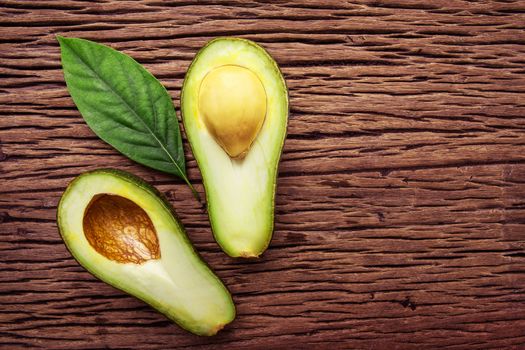 Avocado on a brown wood background.