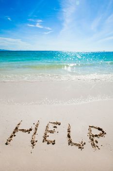 Help Sign on the beach written on sand