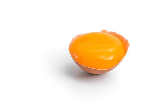 egg yolk in egg shell, cracked egg white isolated on white background