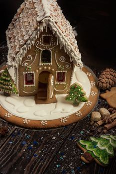 Gingerbread house with lights on dark background, xmas theme