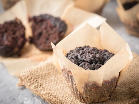 Gluten-free vegan chocolate muffins with beetroot, almond powder, buckwheat flour and karob or cocoa . Homemade cupcakes on gray concrete background with copyspace