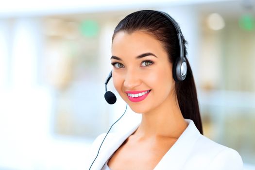 Closeup portrait of support phone operator in headset at workplace