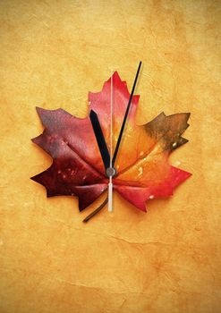 Autumn maple leaf with clock hand