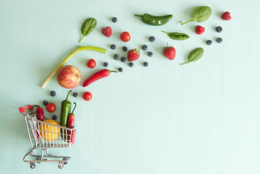 Miniature shopping cart with fruits and vegetables 