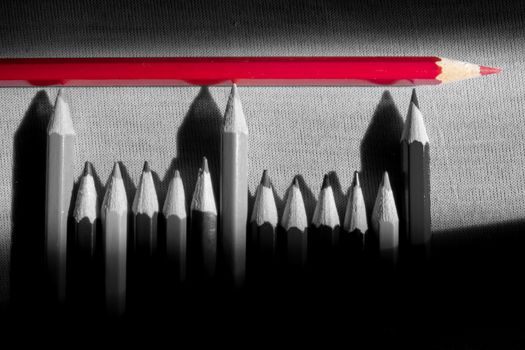 Red pencil on top of many in black and white